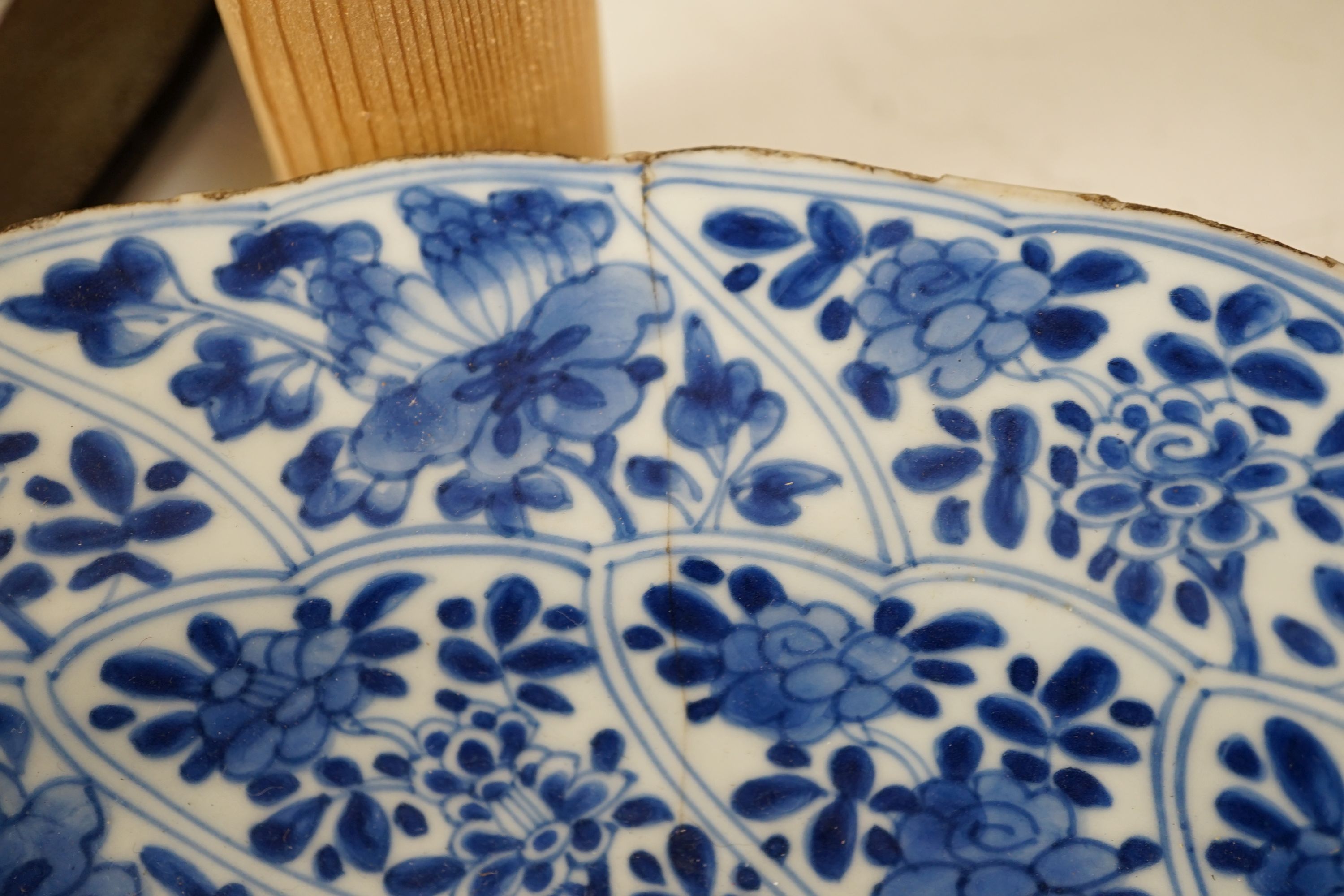 A pair of Chinese Kangxi blue and white dishes, painted with rock work and flowers, artemisia leaf marks, 37cm diameter